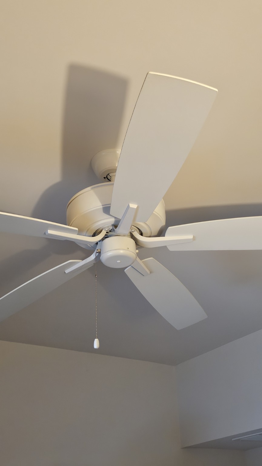 Existing white apartment ceiling fan before a light kit was added