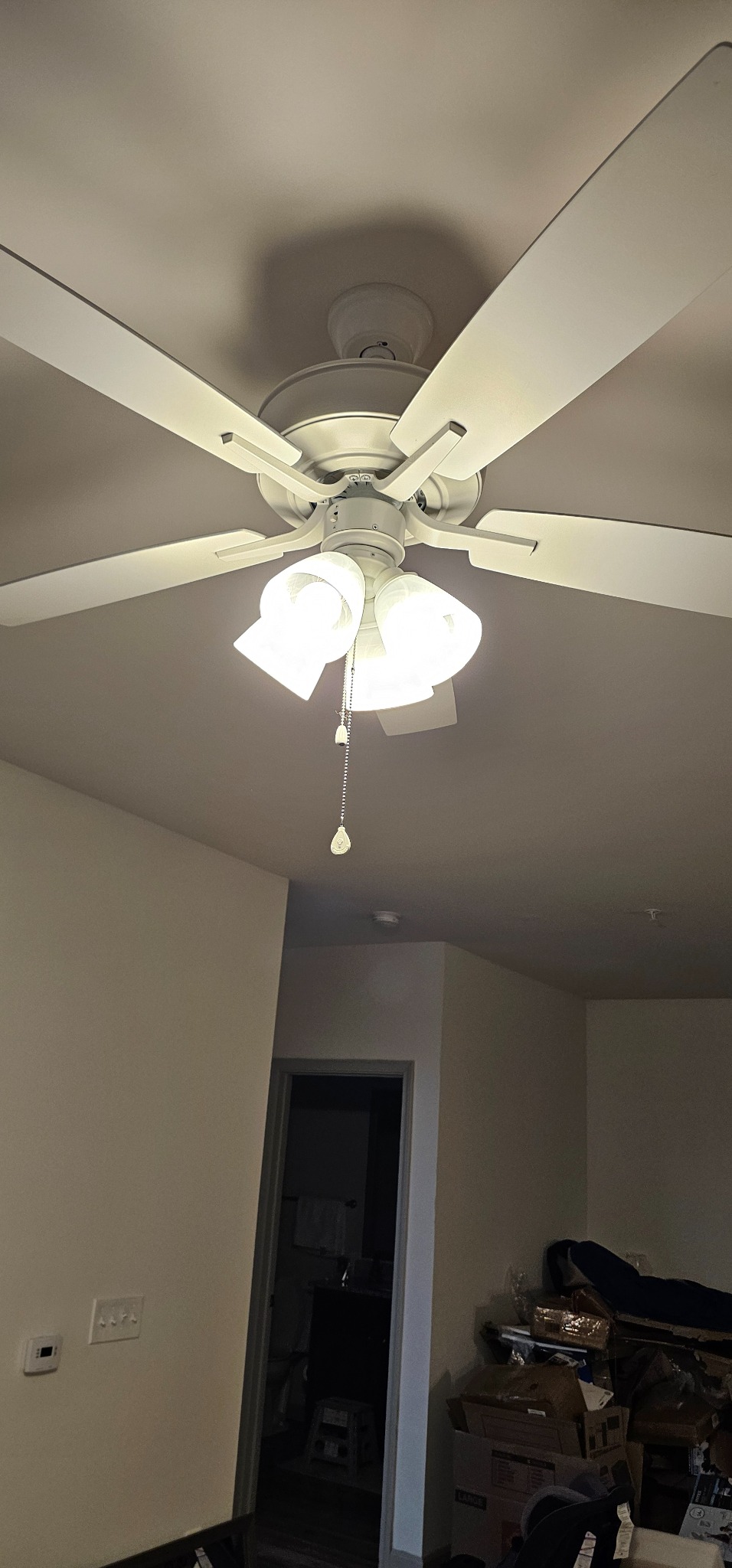 White ceiling fan with installed multi-light kit