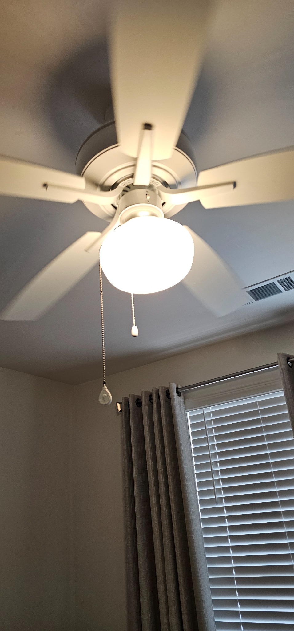 White ceiling fan with installed single-globe light kit
